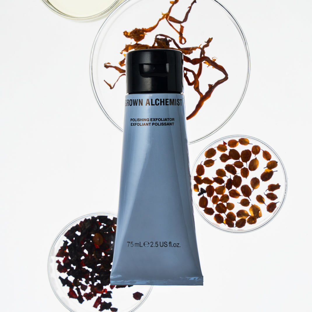 Polishing Exfoliator on a white background, surrounded by small dishes of exfoliating materials.