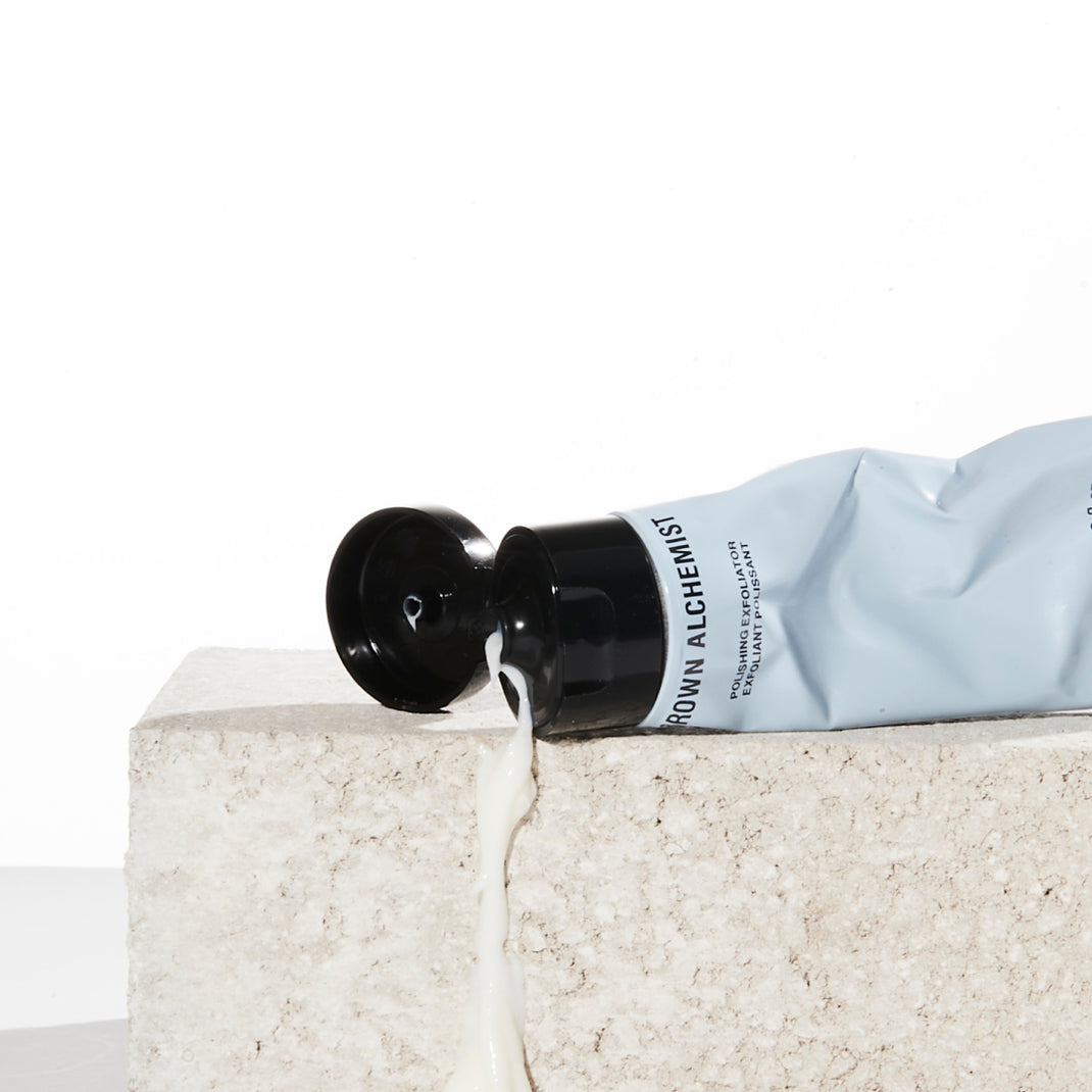 Bottle of Grown Alchemist product being applied to a textured surface