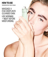 A woman holds a tube of Regenerating Hand Cream against her face, with text on the left explaining how to use the hand cream.