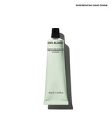 A squeeze tube of Grown Alchemist Regenerating Hand Cream on a clean white background with a soft shadow. The tube is a very pale mint green with black text and a black cap.