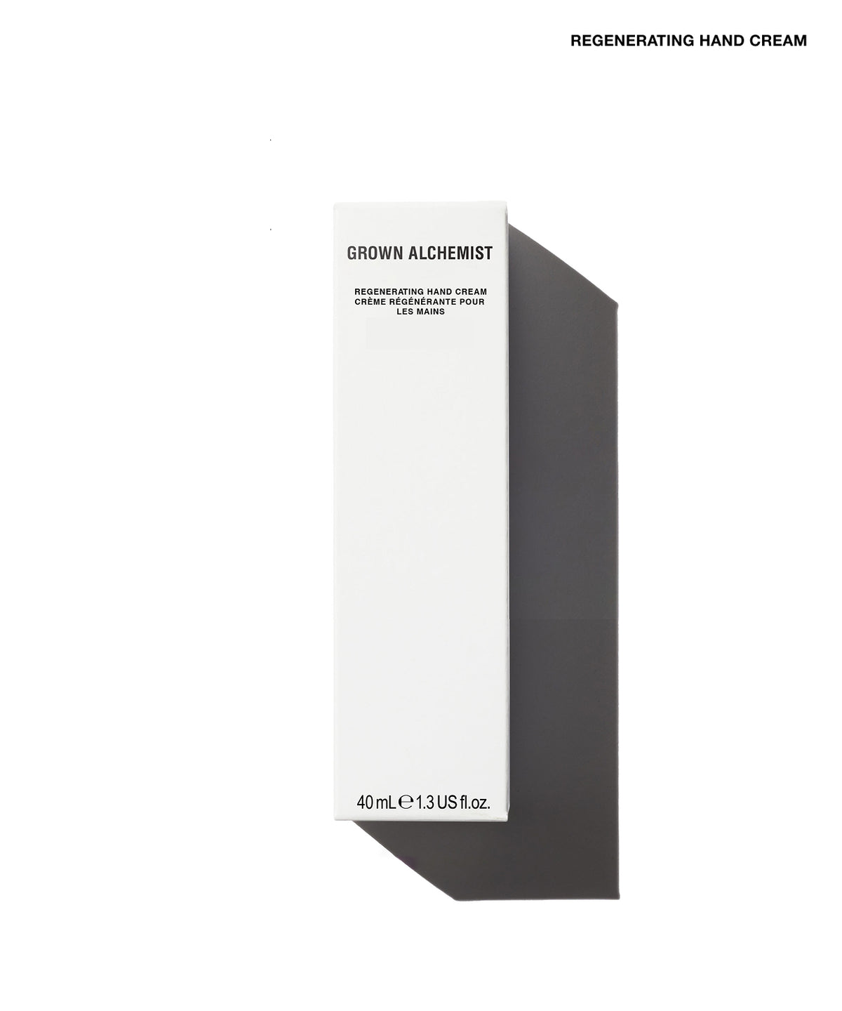 A tall, minimalist white product box for Grown Alchemist Regenerating Hand Cream, shown on a clean white background with a sharp dark shadow to the right. The text 'REGENERATING HAND CREAM' is printed at the top right of the image.