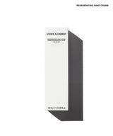 A tall, minimalist white product box for Grown Alchemist Regenerating Hand Cream, shown on a clean white background with a sharp dark shadow to the right. The text 'REGENERATING HAND CREAM' is printed at the top right of the image.
