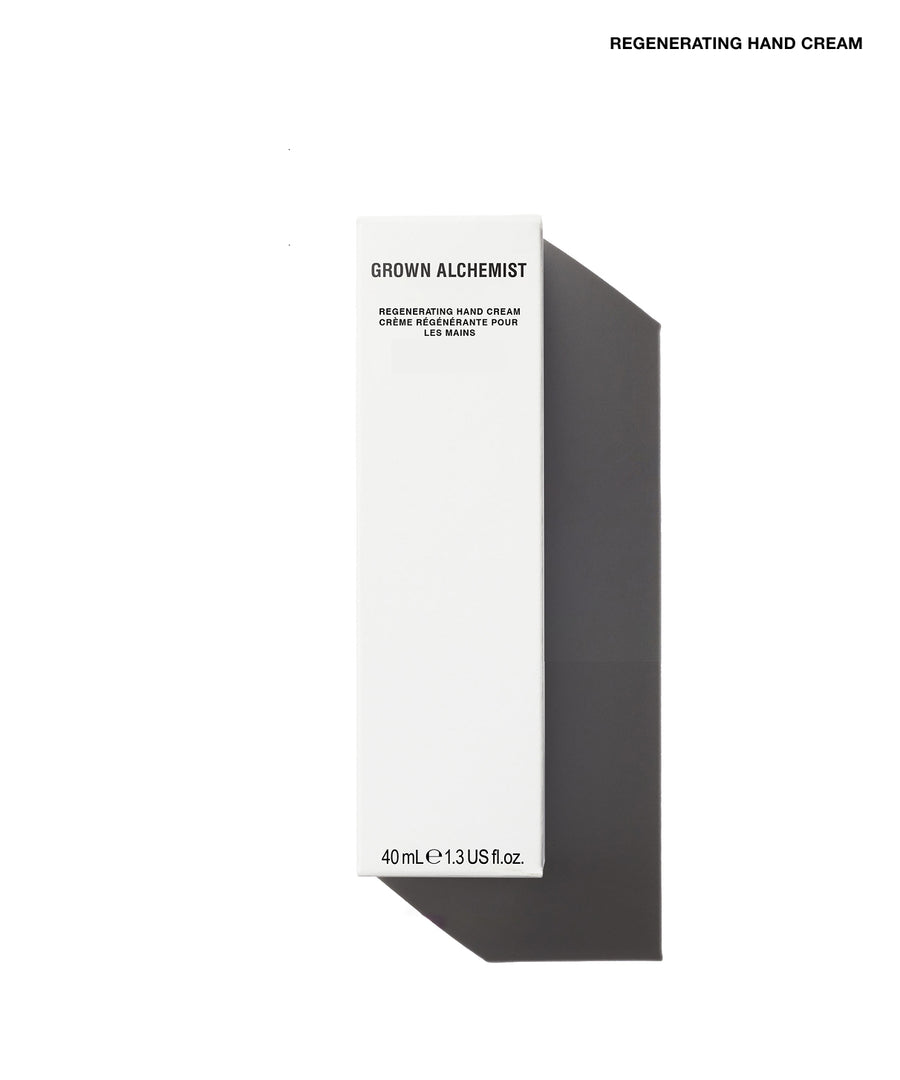 A tall, minimalist white product box for Grown Alchemist Regenerating Hand Cream, shown on a clean white background with a sharp dark shadow to the right. The text 'REGENERATING HAND CREAM' is printed at the top right of the image.