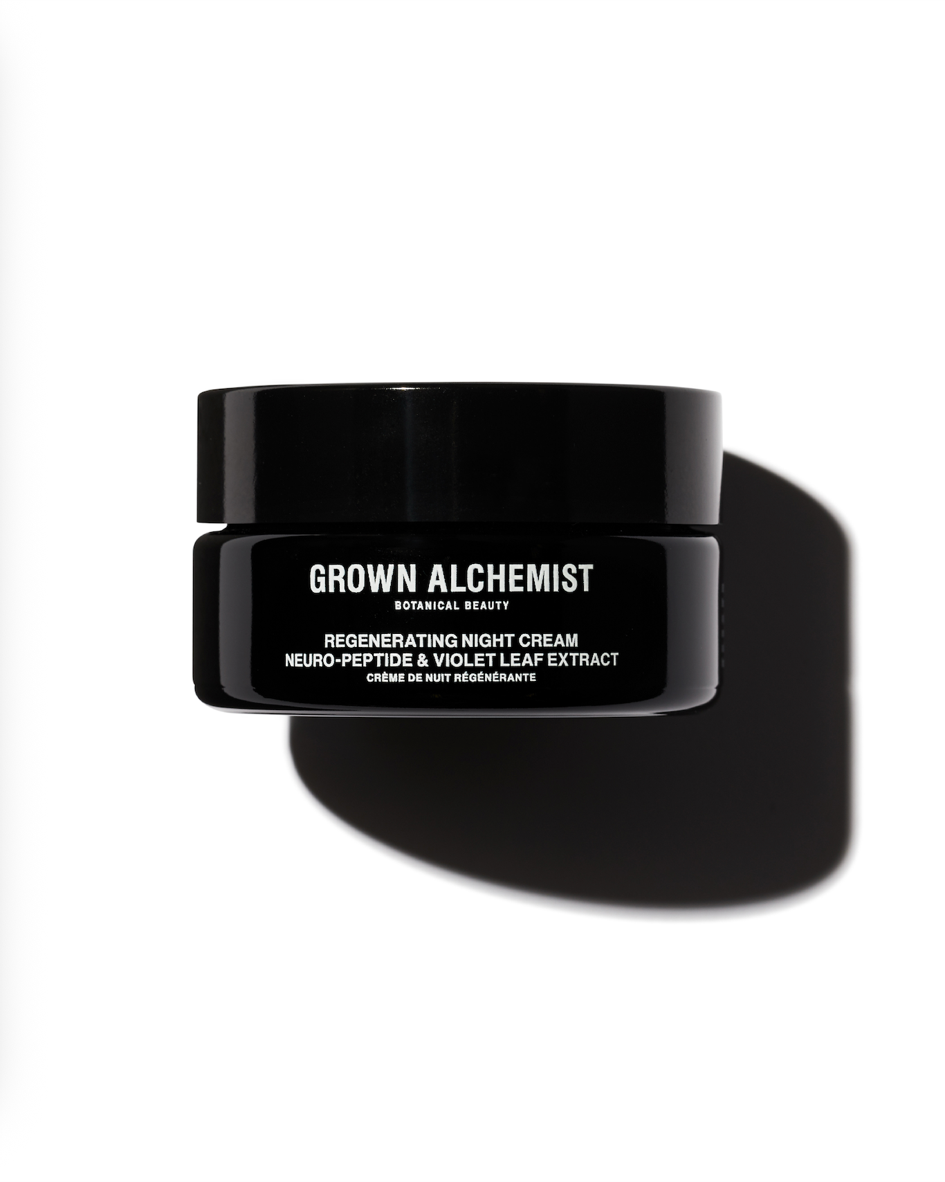 Black jar of Grown Alchemist regenerating night cream on a white background