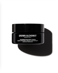 Black jar of Grown Alchemist regenerating night cream on a white background