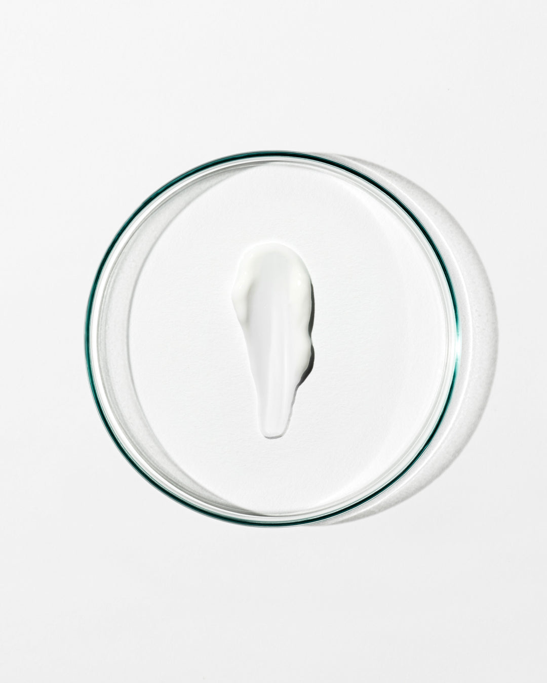 Glass container with a white lid on a white background