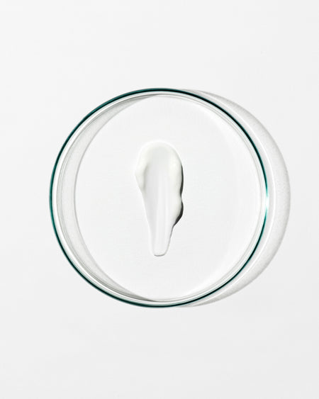 Glass container with a white lid on a white background