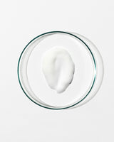 Glass bowl with a white creamy substance on a white background