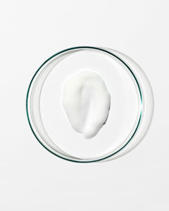 Glass bowl with a white creamy substance on a white background