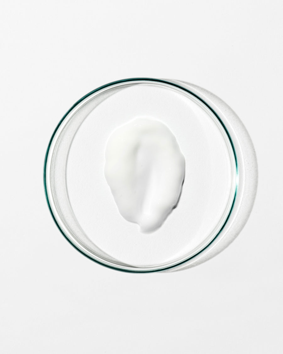 Glass bowl with a white creamy substance on a white background