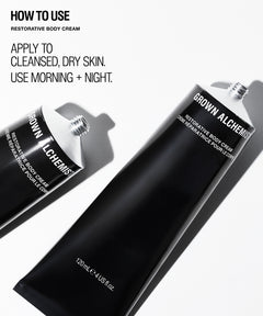Two black tubes of Grown Alchemist Restorative Body Cream on a white background with 'HOW TO USE' text on the left.