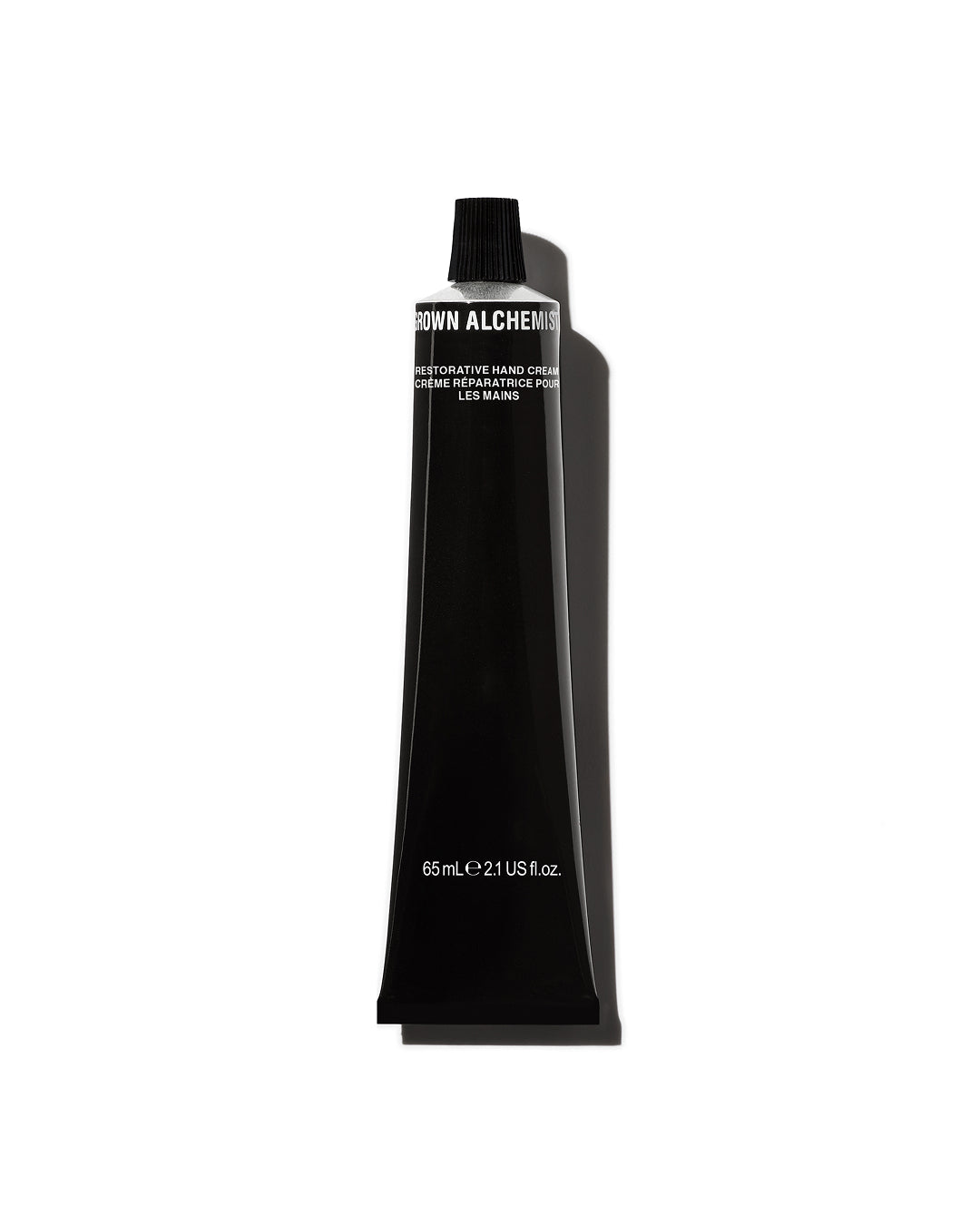 Black tube of Grown Alchemist hand cream on a white background