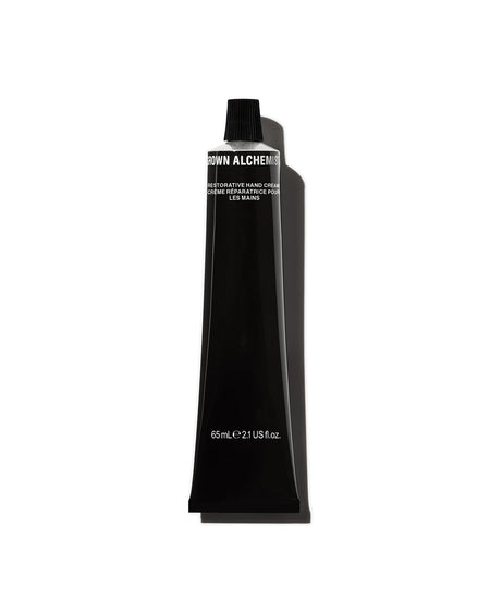 Black tube of Grown Alchemist hand cream on a white background