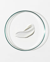 White cream on a clear glass plate with a white background