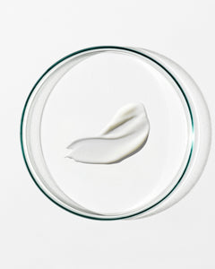 White cream on a clear glass plate with a white background