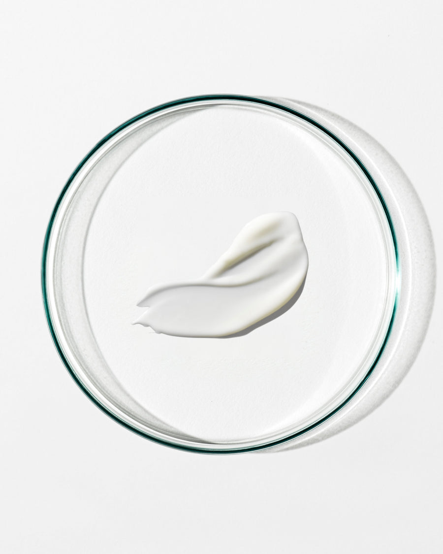 White cream on a clear glass plate with a white background