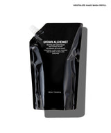 A black refill pouch of Grown Alchemist Revitalize Hand Wash on a white background with a gray shadow.