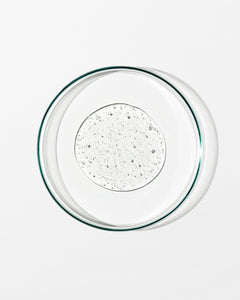Clear glass bowl with a textured white liquid on a white background