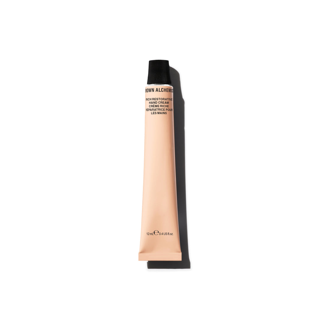 Hand cream tube with black cap on a white background
