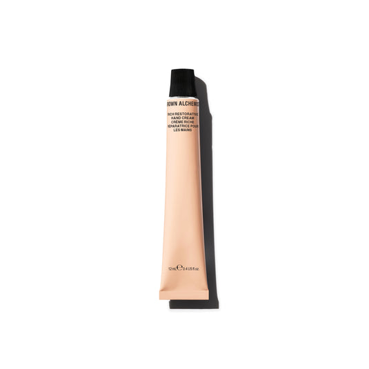 Hand cream tube with black cap on a white background