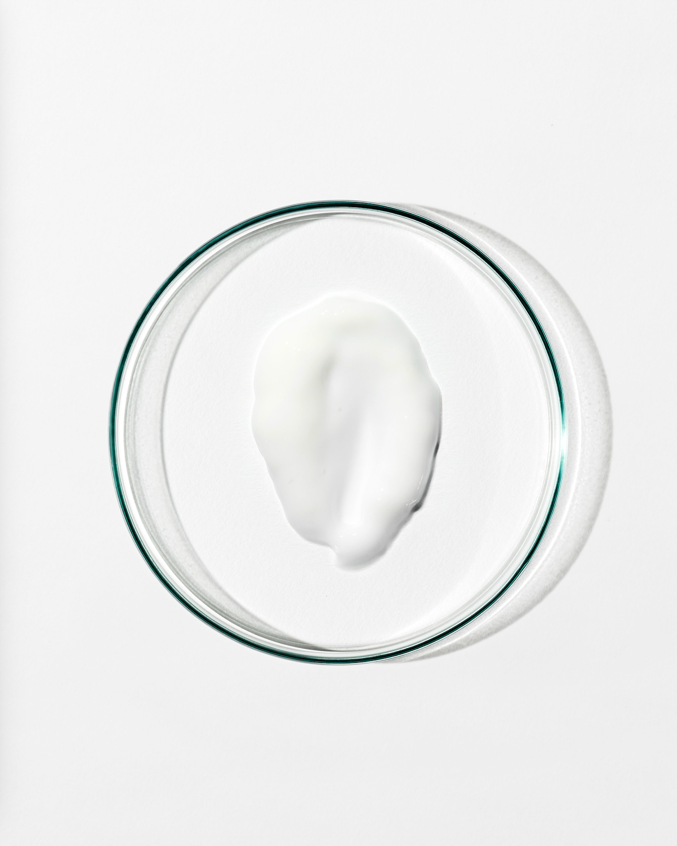 Glass bowl with a white substance on a white background