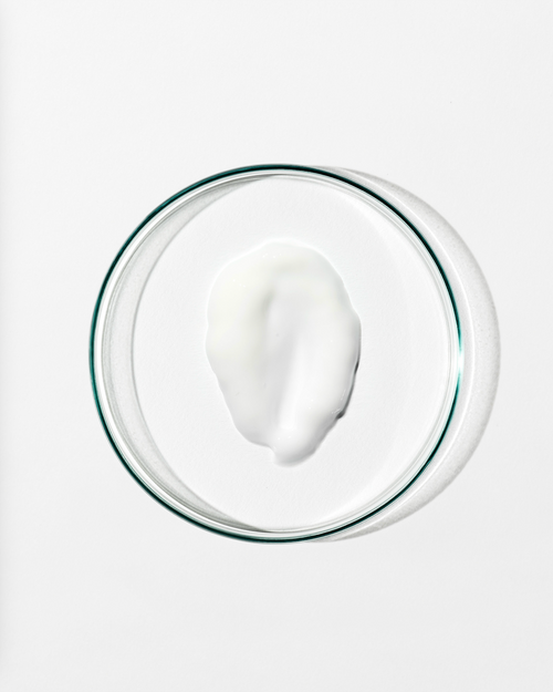 Glass bowl with a white substance on a white background
