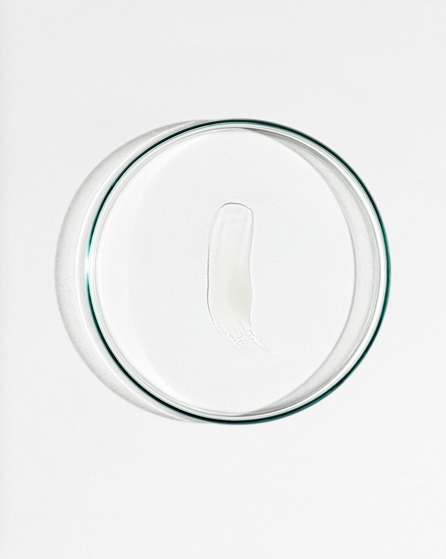 Clear glass lid with white cream on a white background
