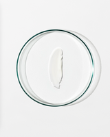 Clear dish with a dollop of white cream against a white background