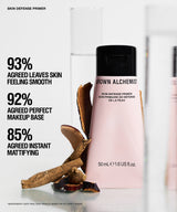 Grown Alchemist Skin Defense Primer bottle in a soft pink shade with a black cap, displayed alongside natural brown botanical ingredients on a clean white background with promotional text.