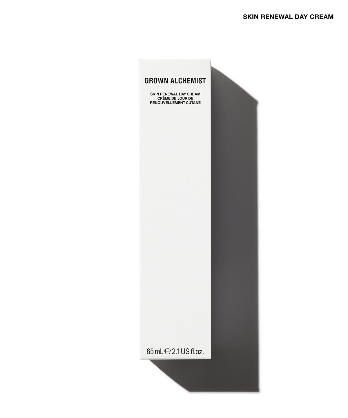 A tall, narrow white box for Grown Alchemist Skin Renewal Day Cream, shown on a clean white background with a dark gray shadow. The box has black text and is positioned vertically, with 'SKIN RENEWAL DAY CREAM' printed in black at the top right of the image.