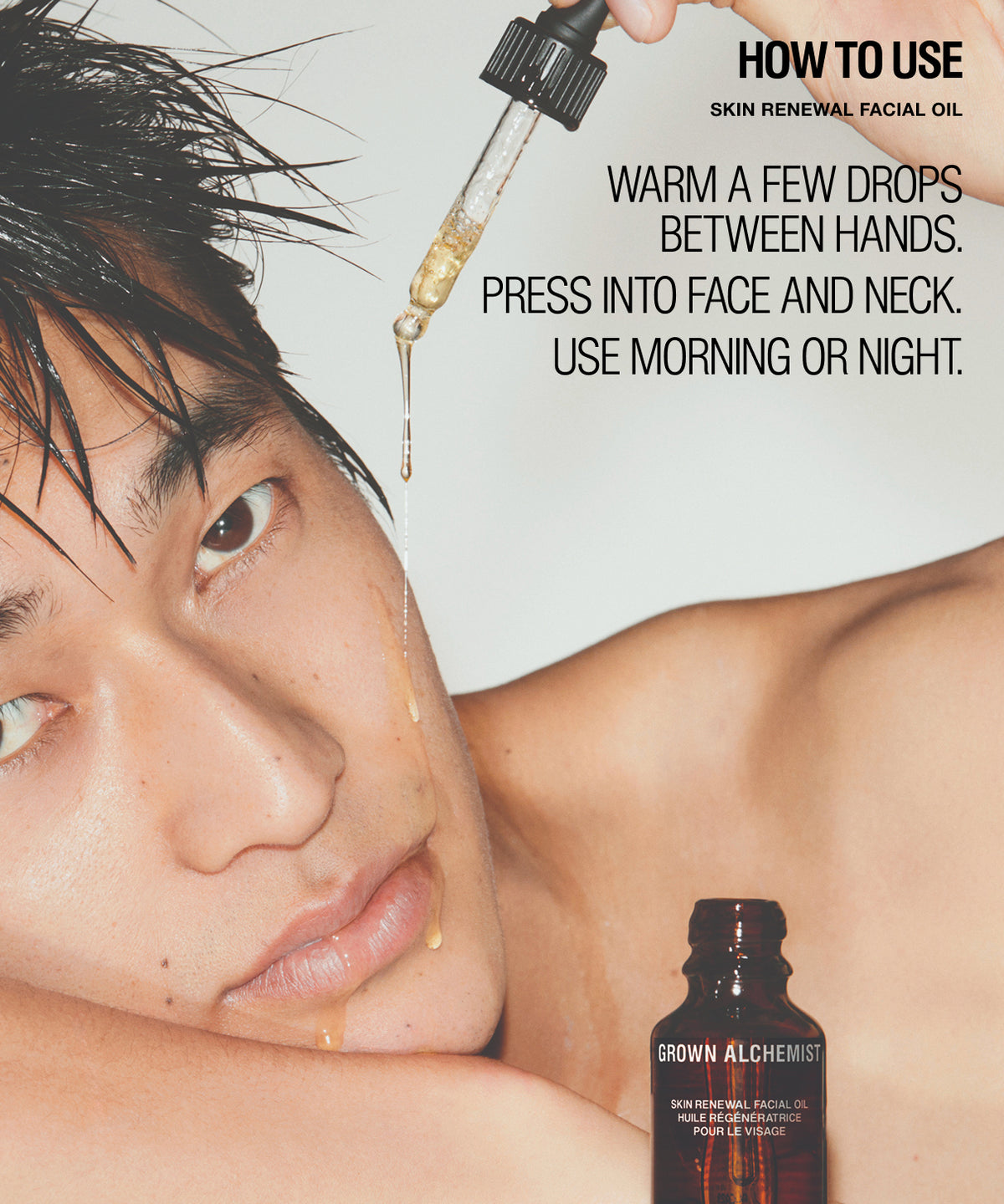 A close-up skincare instructional graphic showing a man's face with wet hair, a dropper above his face, and a small brown bottle labeled Grown Alchemist. Text reads: 'HOW TO USE SKIN RENEWAL FACIAL OIL' and instructions on applying the oil.