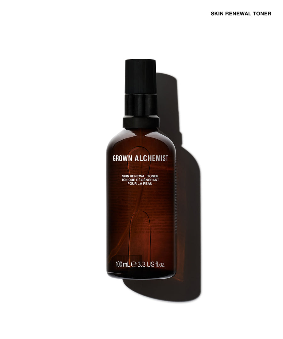 A 100 mL bottle of Grown Alchemist Skin Renewal Toner, made of dark amber glass with a black spray pump cap, shown on a white background with a prominent cast shadow.