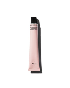 Pink cosmetic tube with black cap on a white background