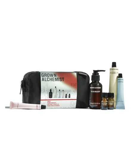 Grown Alchemist hair care product set with black pouch on a white background