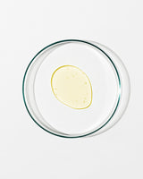 Clear glass bowl with a yellow substance on a white background