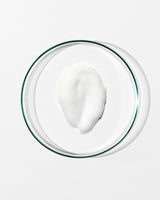 Glass bowl with a white substance on a white background