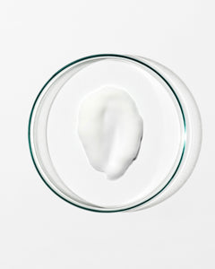 Glass bowl with a white substance on a white background