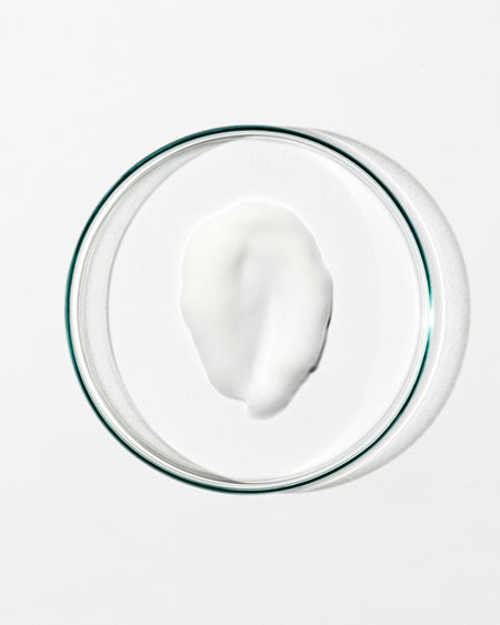 Glass bowl with a white substance on a white background