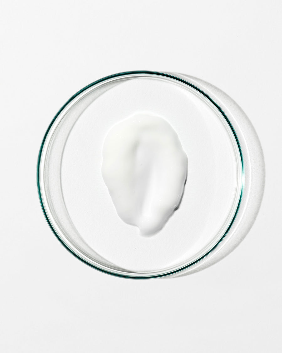 Glass bowl with a white substance on a white background