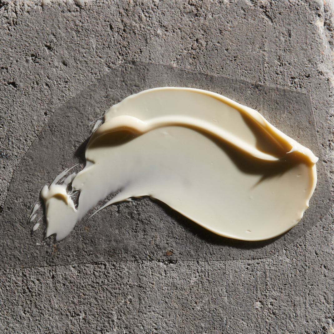 White cream smear on a gray concrete surface