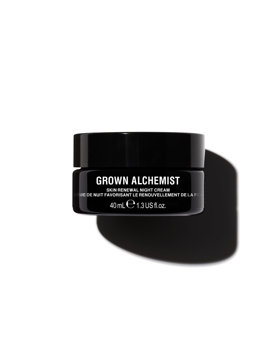 Black jar of Grown Alchemist skin renewal night cream on a white background
