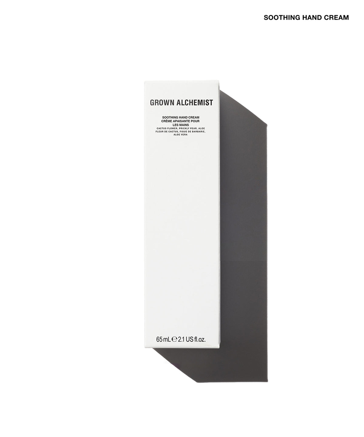 A tall, narrow white product box for Grown Alchemist Soothing Hand Cream, shown on a clean white background with a dark gray shadow. The box features black text and is positioned vertically with a diagonal shadow extending to the right.