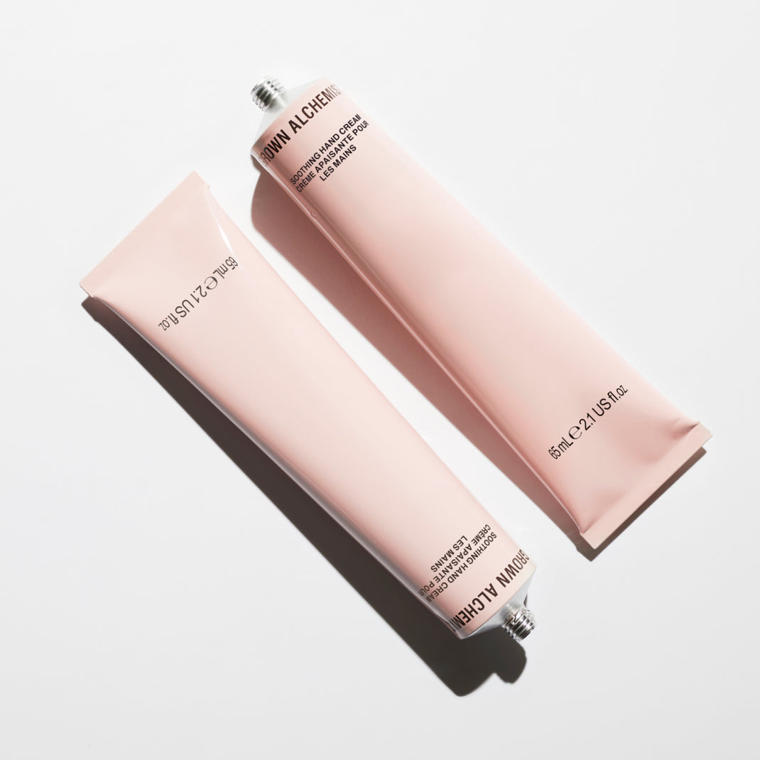 Two pink Soothing Hand Cream on a light gray background