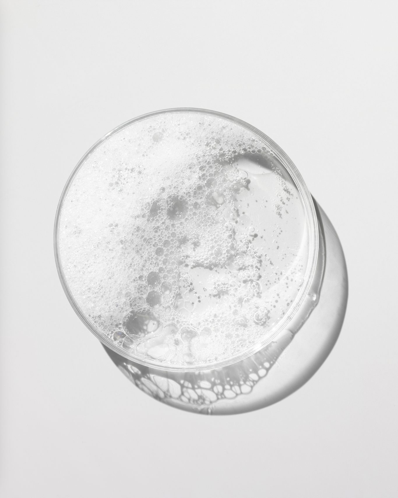Clear glass with bubbles on a light gray background