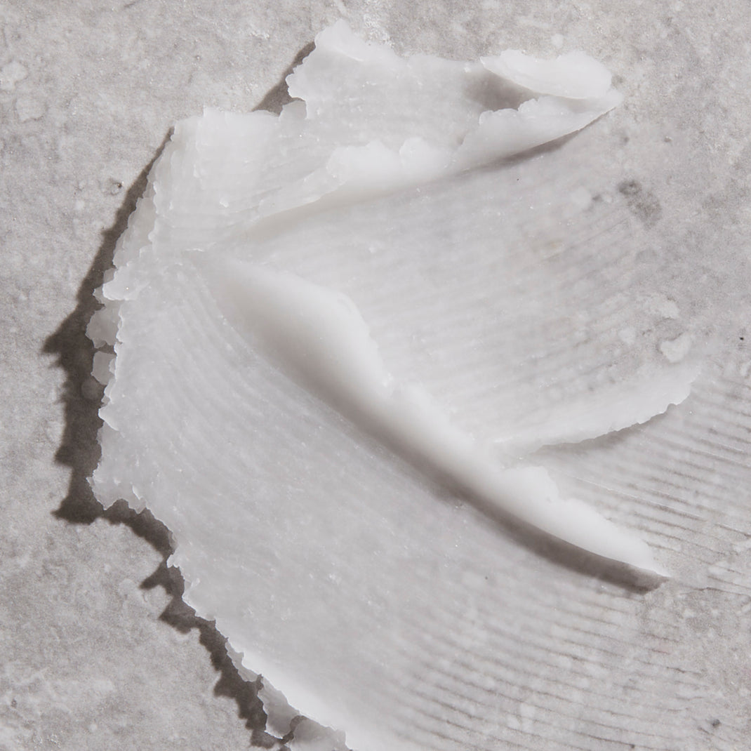 Close-up of a primer spread over a textured light gray surface
