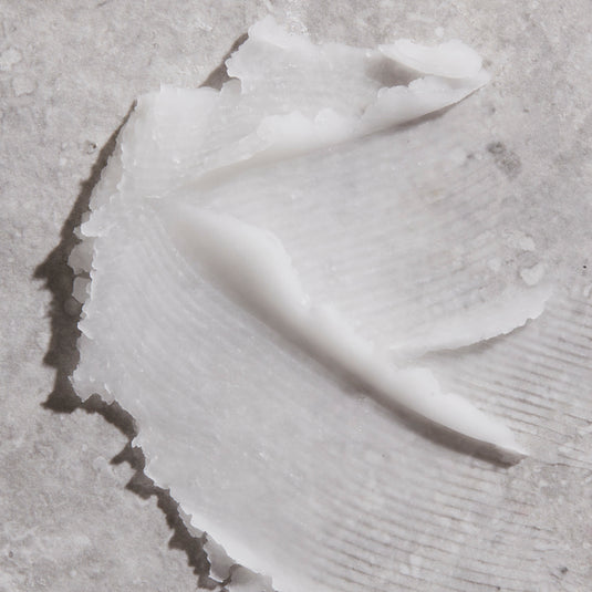 Close-up of a primer spread over a textured light gray surface