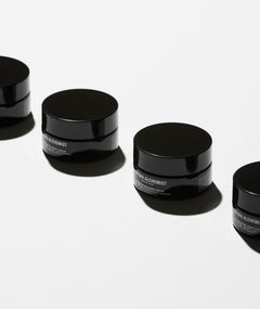 Jars of Regenerating night cream on white background.