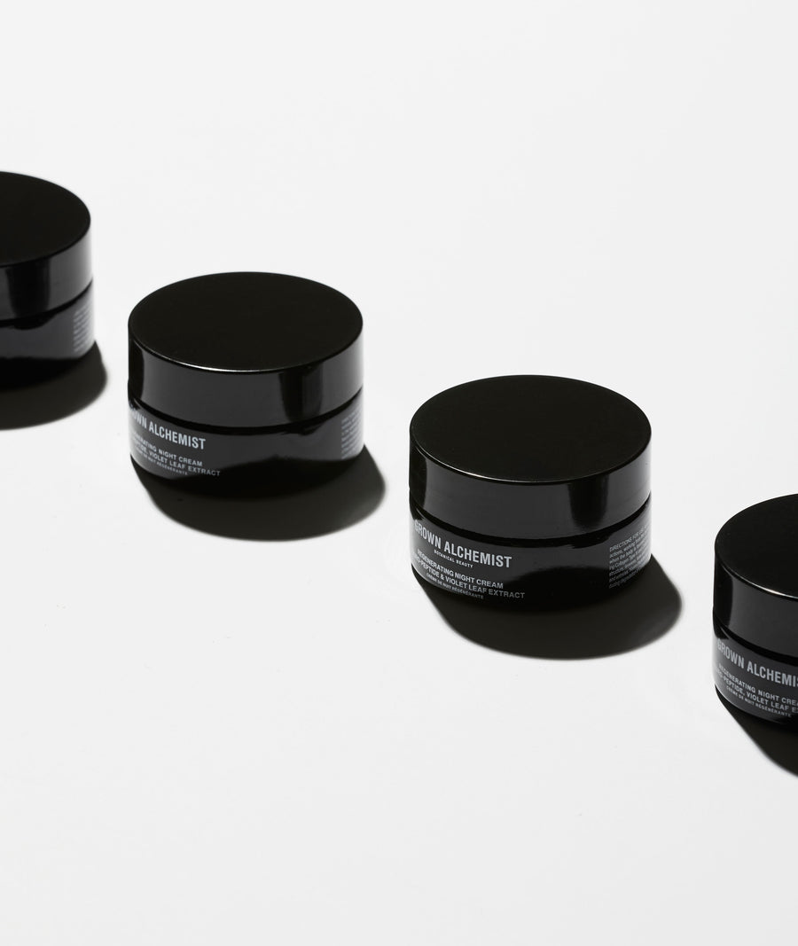 Jars of Regenerating night cream on white background.